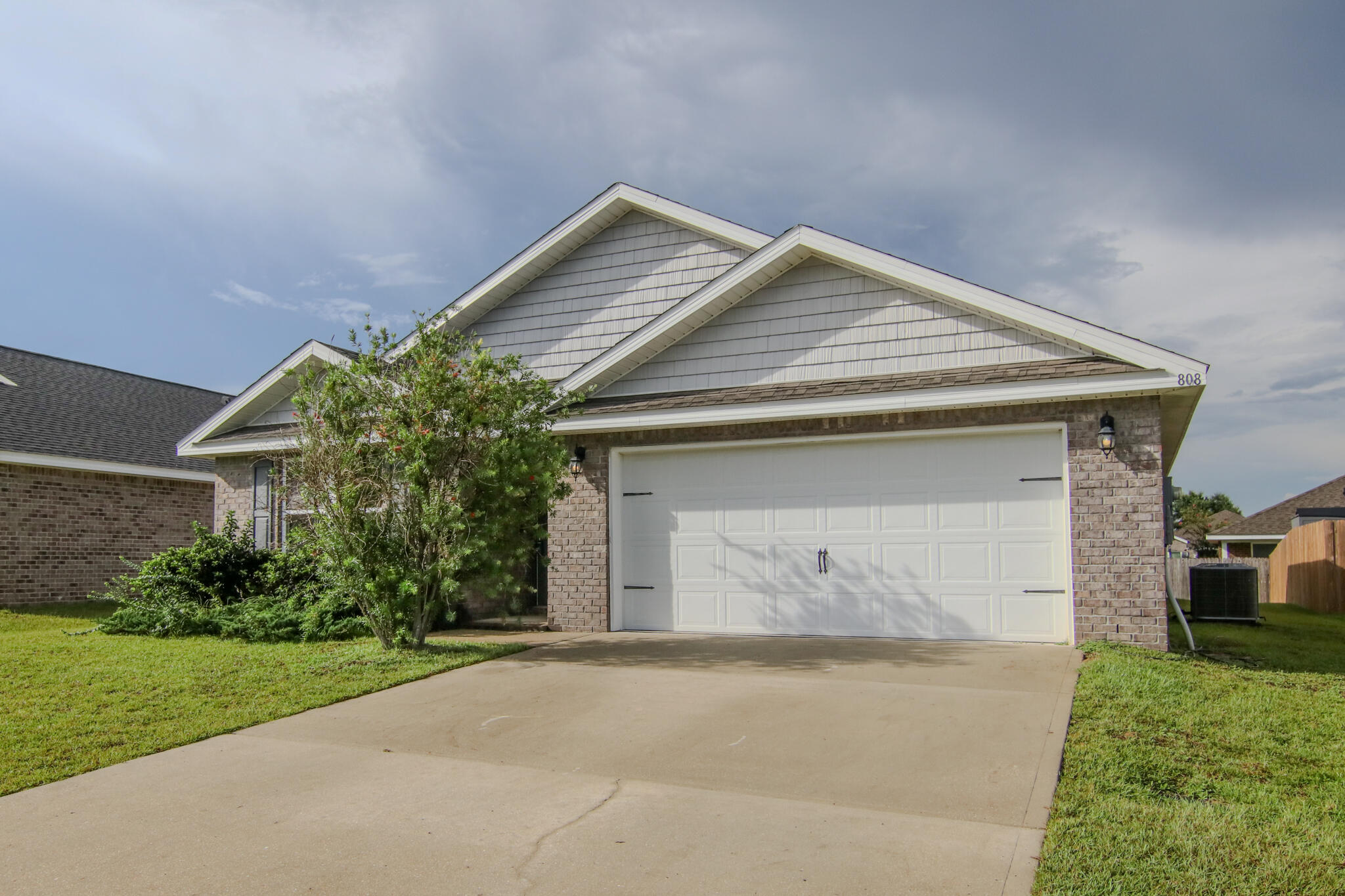 808 Moorhen Way Crestview, FL 32539 - Photo 3 of 47 a front view of a house with a yard and garage