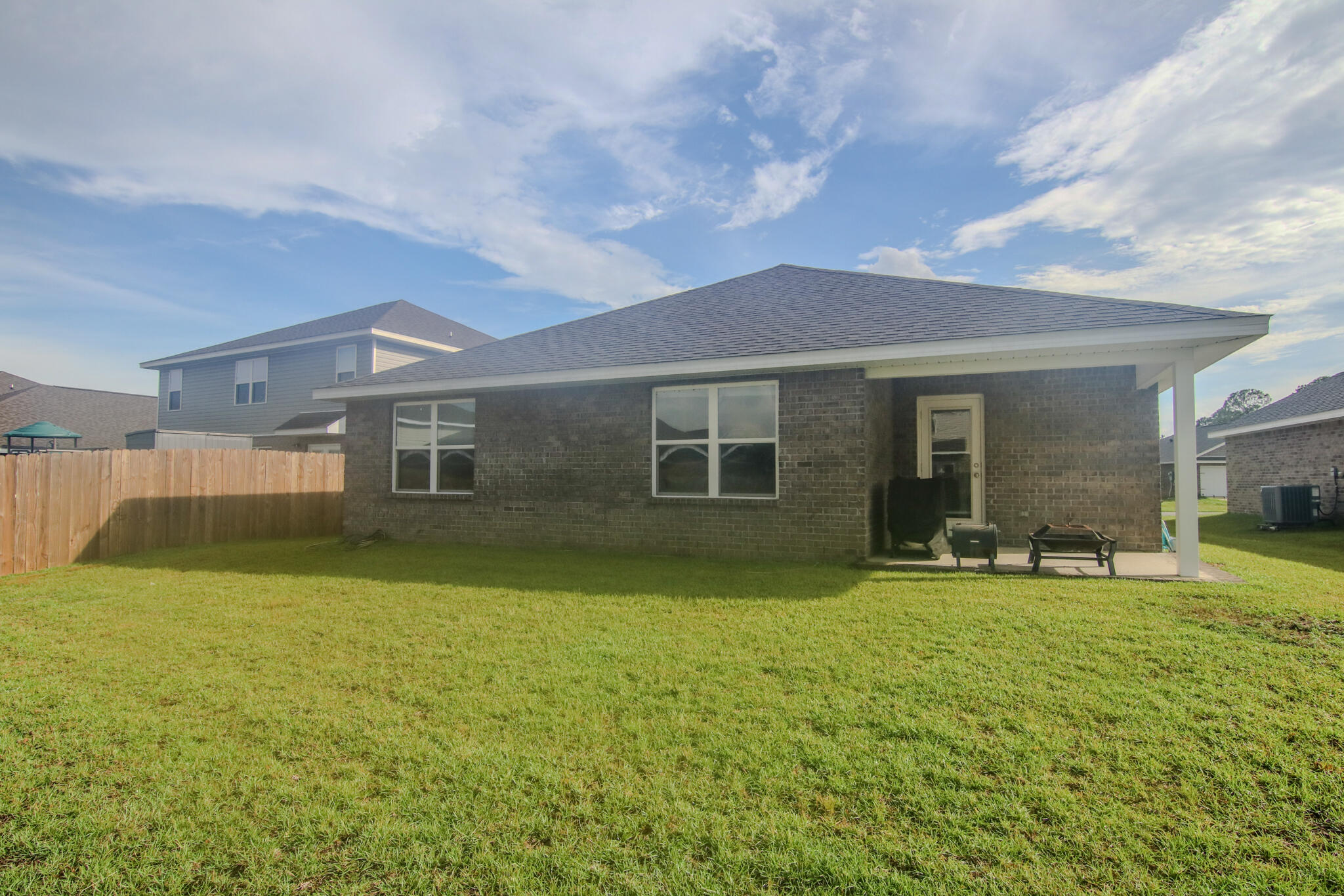 808 Moorhen Way Crestview, FL 32539 - Photo 33 of 47 a front view of a house with a garden and trees