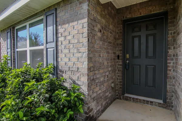 a dining hall with stainless steel appliances granite countertop a dining table and chairs with wooden floor
