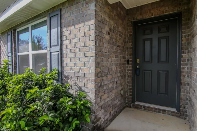 a dining hall with stainless steel appliances granite countertop a dining table and chairs with wooden floor
