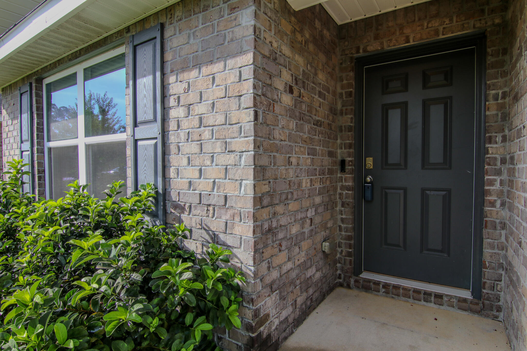808 Moorhen Way Crestview, FL 32539 - Photo 35 of 47 a brick building with a window and a yard