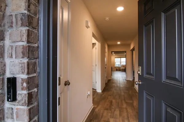 a view of hallway with wooden floor