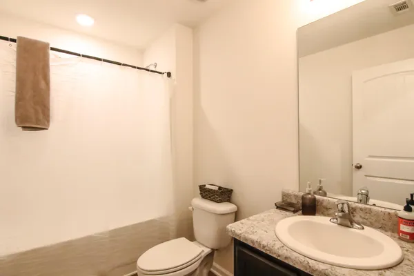 a kitchen with a table chairs refrigerator and microwave