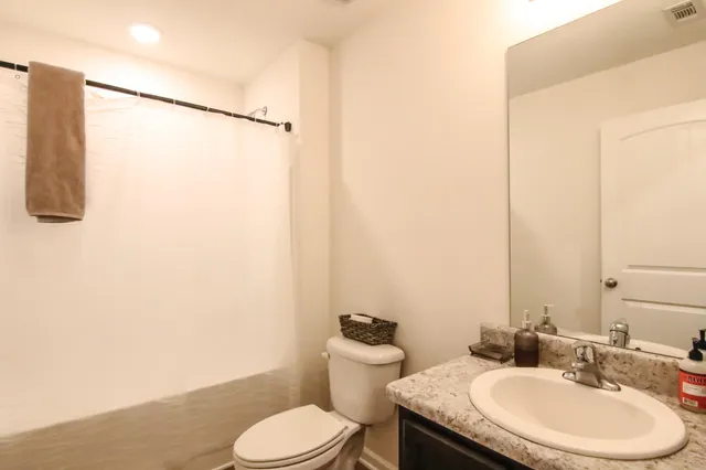 a kitchen with a table chairs refrigerator and microwave