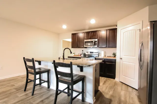 a kitchen with sink a faucet and appliances