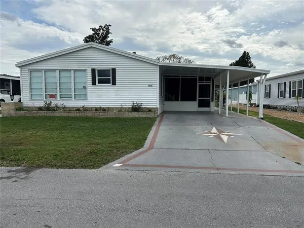 a front view of a house with a garden and porch