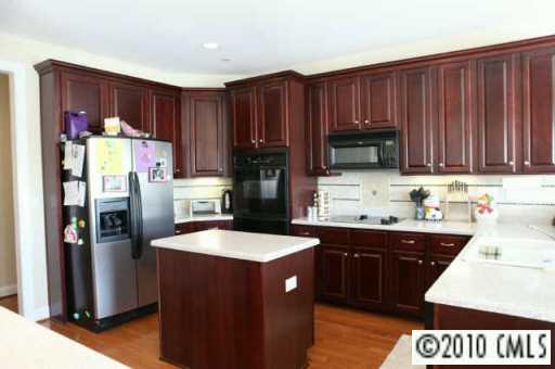 314 Chancelot Lane Fort Mill, SC 29708 - Photo 4 of 8 a kitchen with stainless steel appliances a sink a stove a refrigerator and cabinets