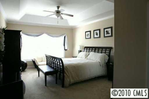 314 Chancelot Lane Fort Mill, SC 29708 - Photo 8 of 8 a bedroom with a bed and a chandelier