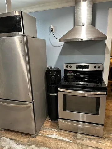 a stove top oven sitting inside of a kitchen