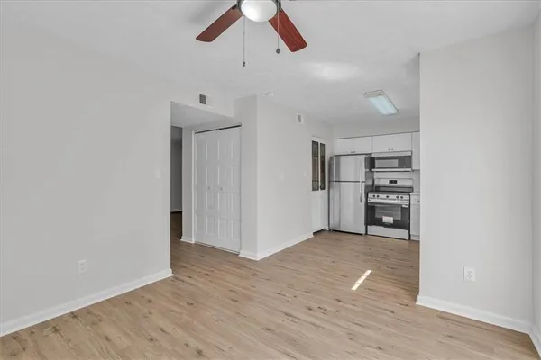 a kitchen with cabinets stainless steel appliances a sink and a window