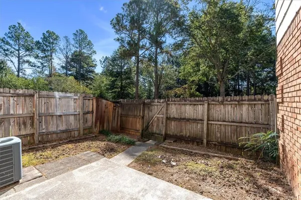 a view of a house with a yard and furniture