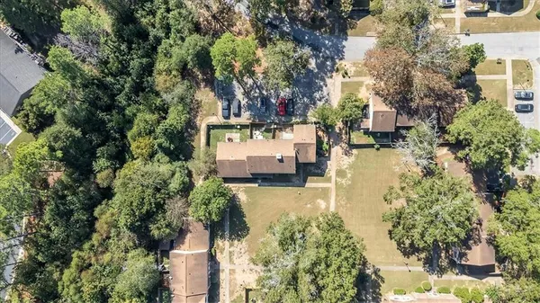an aerial view of a house with a yard