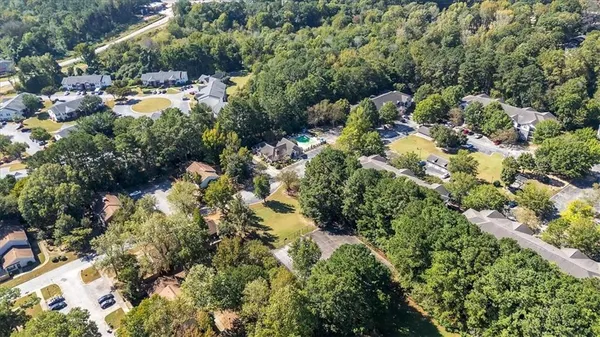 an aerial view of residential house with outdoor space and trees