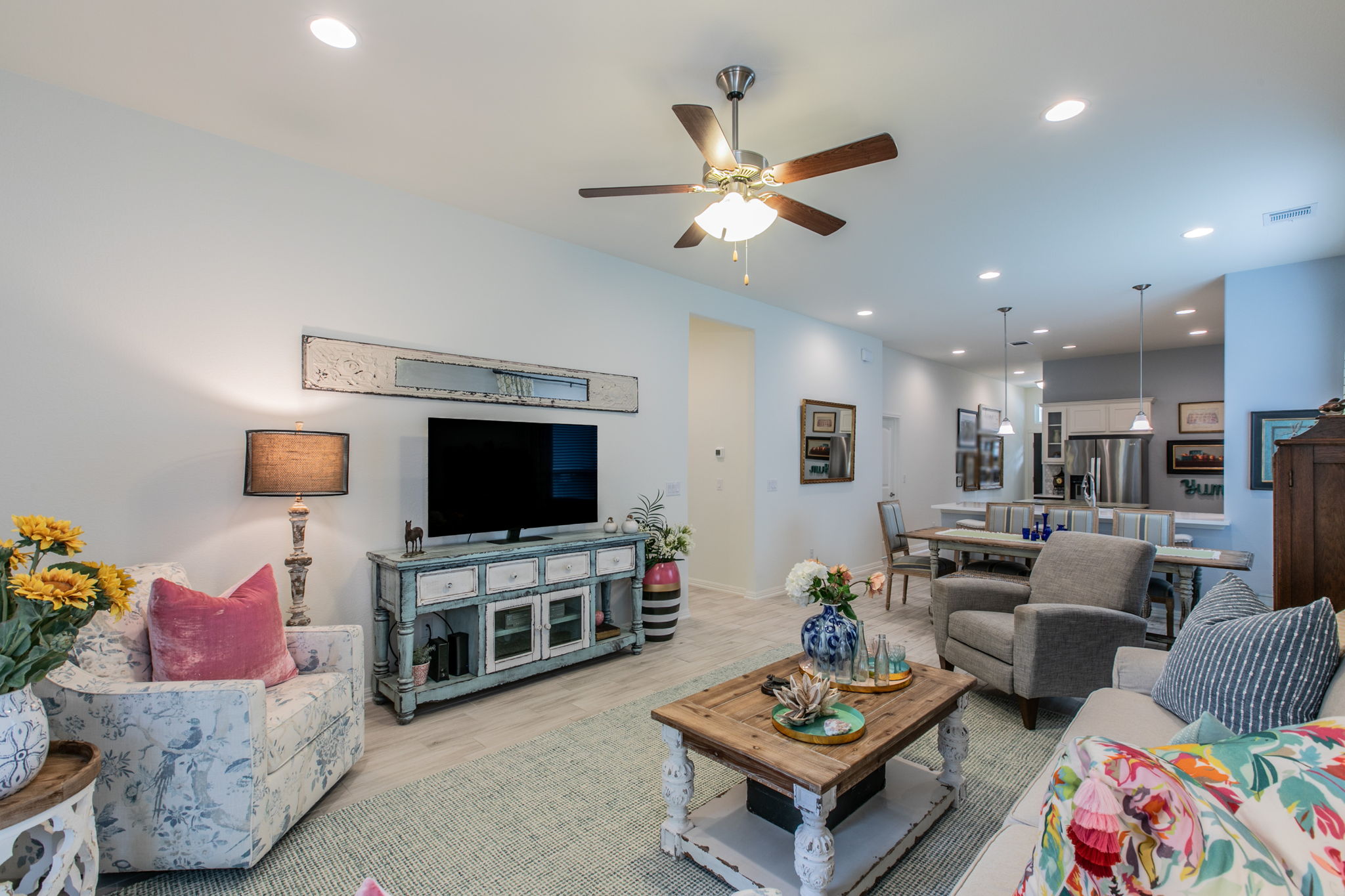 231 Simon Kyle, TX 78640 - Photo 7 of 29 Open-concept living area featuring light wood-finish flooring, recessed lighting, and a ceiling fan