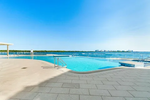 a view of outdoor space with swimming pool and lake view