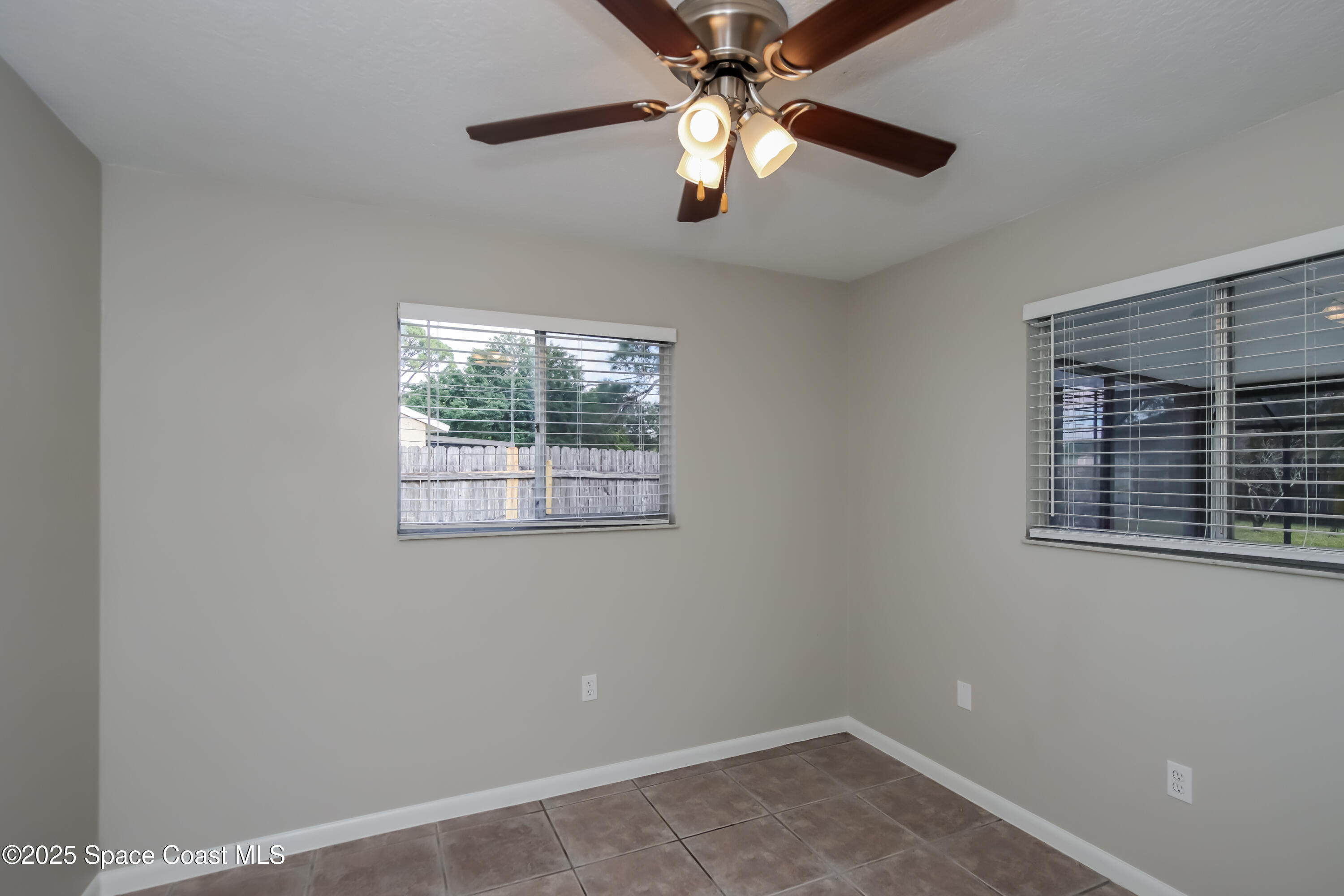 1130 Emerald Road Southeast Palm Bay, FL 32909 - Photo 11 of 16 an empty room with a window and a fan