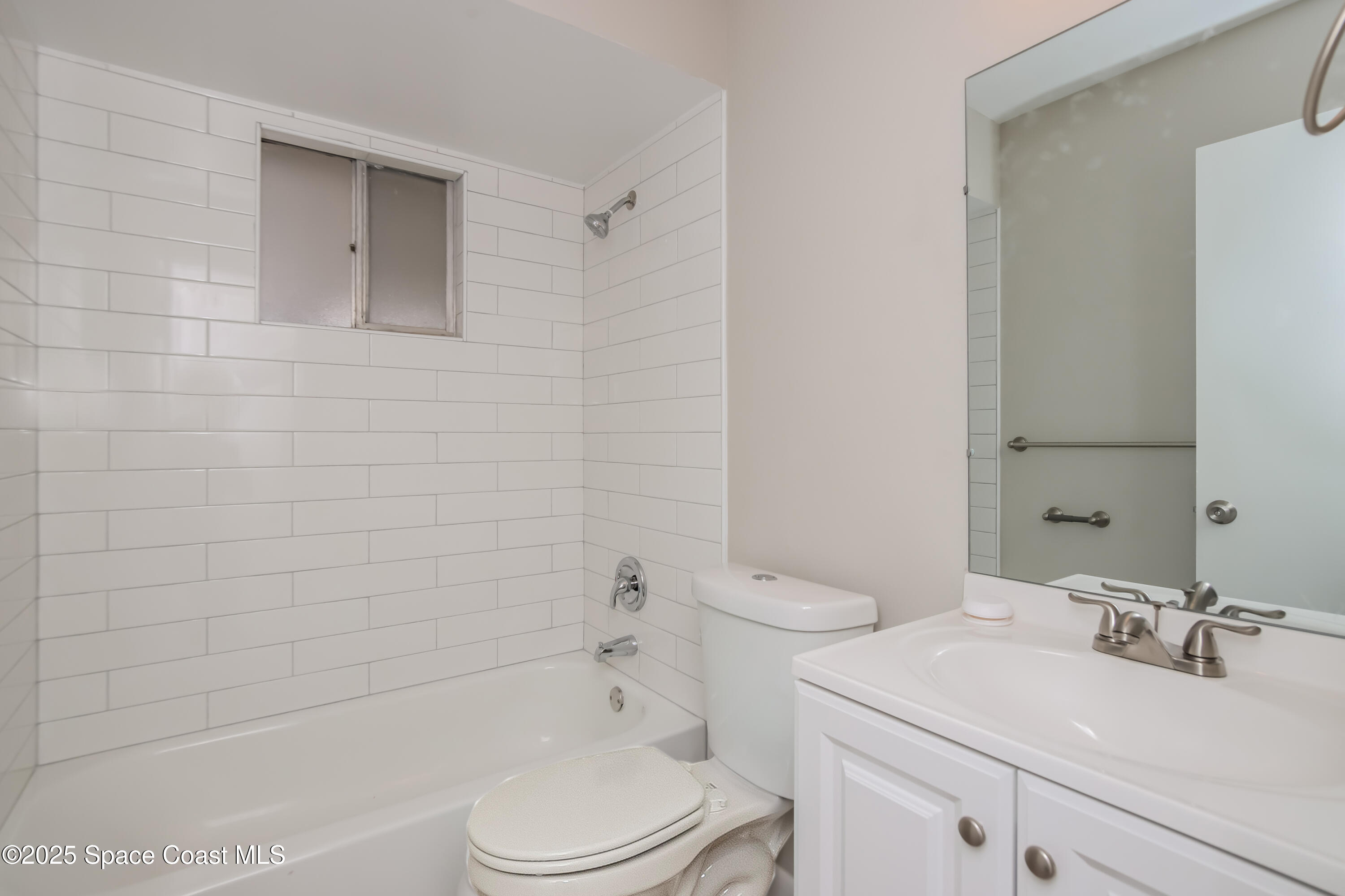 1130 Emerald Road Southeast Palm Bay, FL 32909 - Photo 12 of 16 a bathroom with a sink toilet and shower
