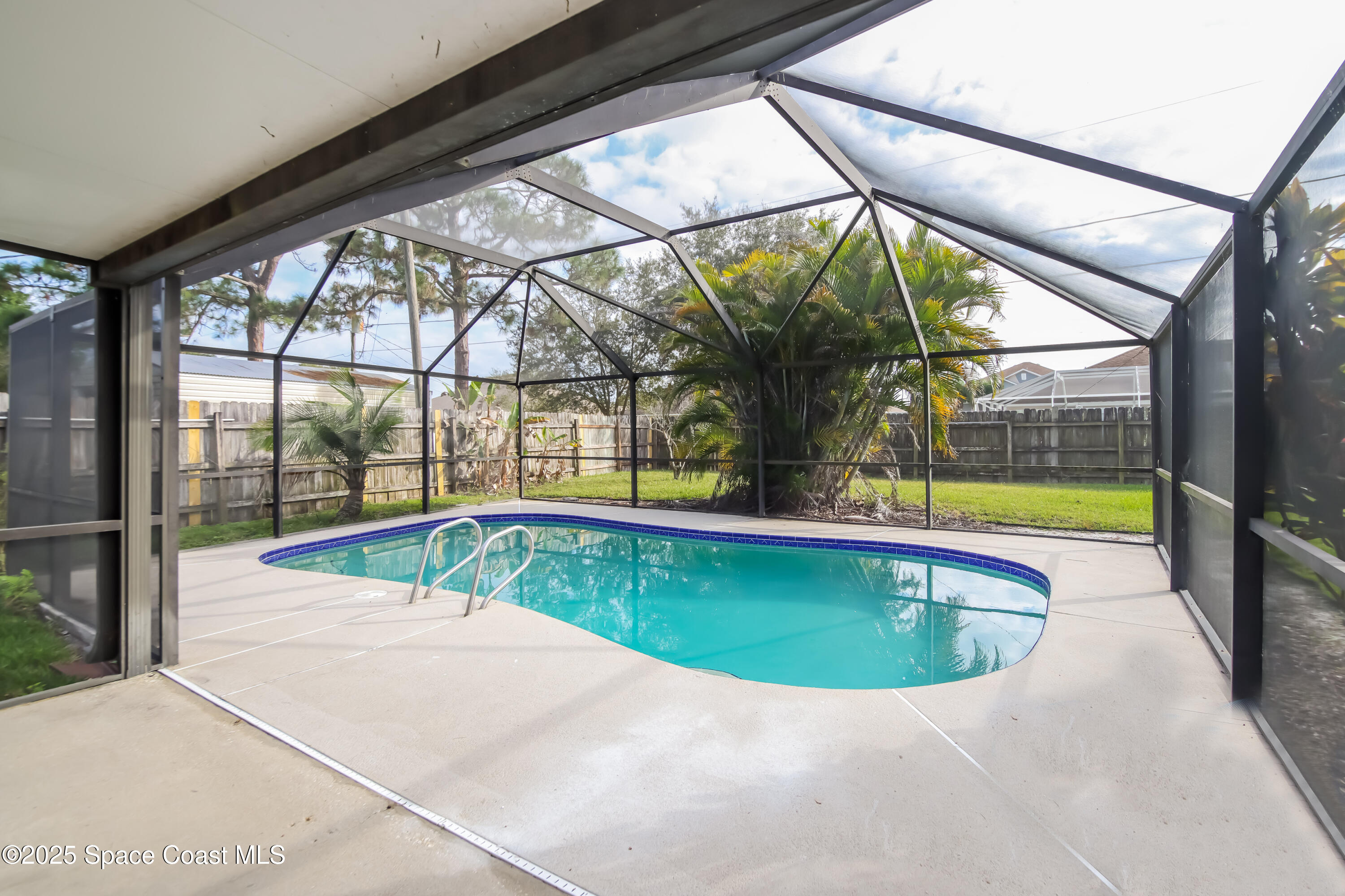 1130 Emerald Road Southeast Palm Bay, FL 32909 - Photo 13 of 16 a view of a swimming pool with a porch
