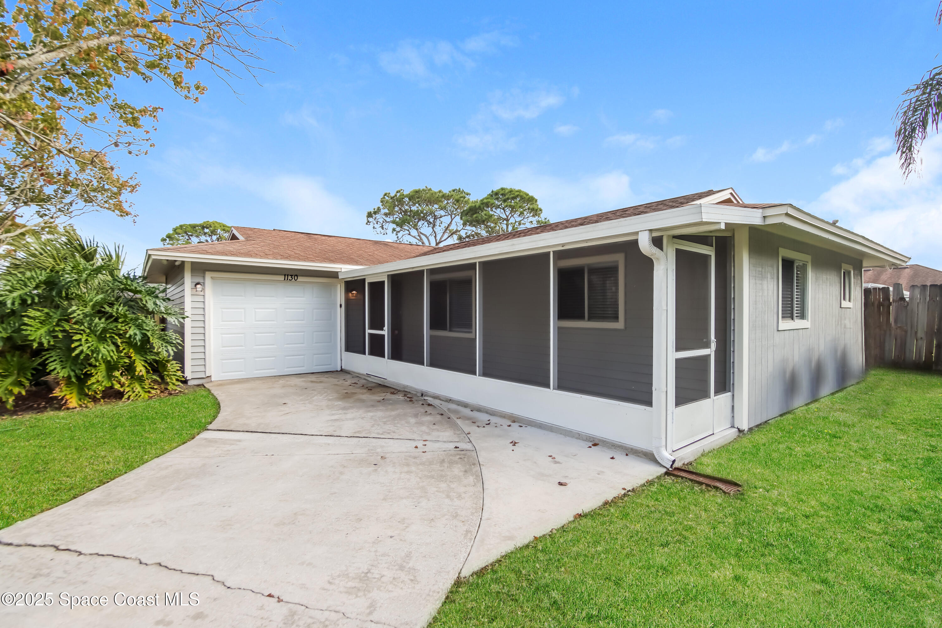 1130 Emerald Road Southeast Palm Bay, FL 32909 - Photo 2 of 16 a front view of a house with a garden