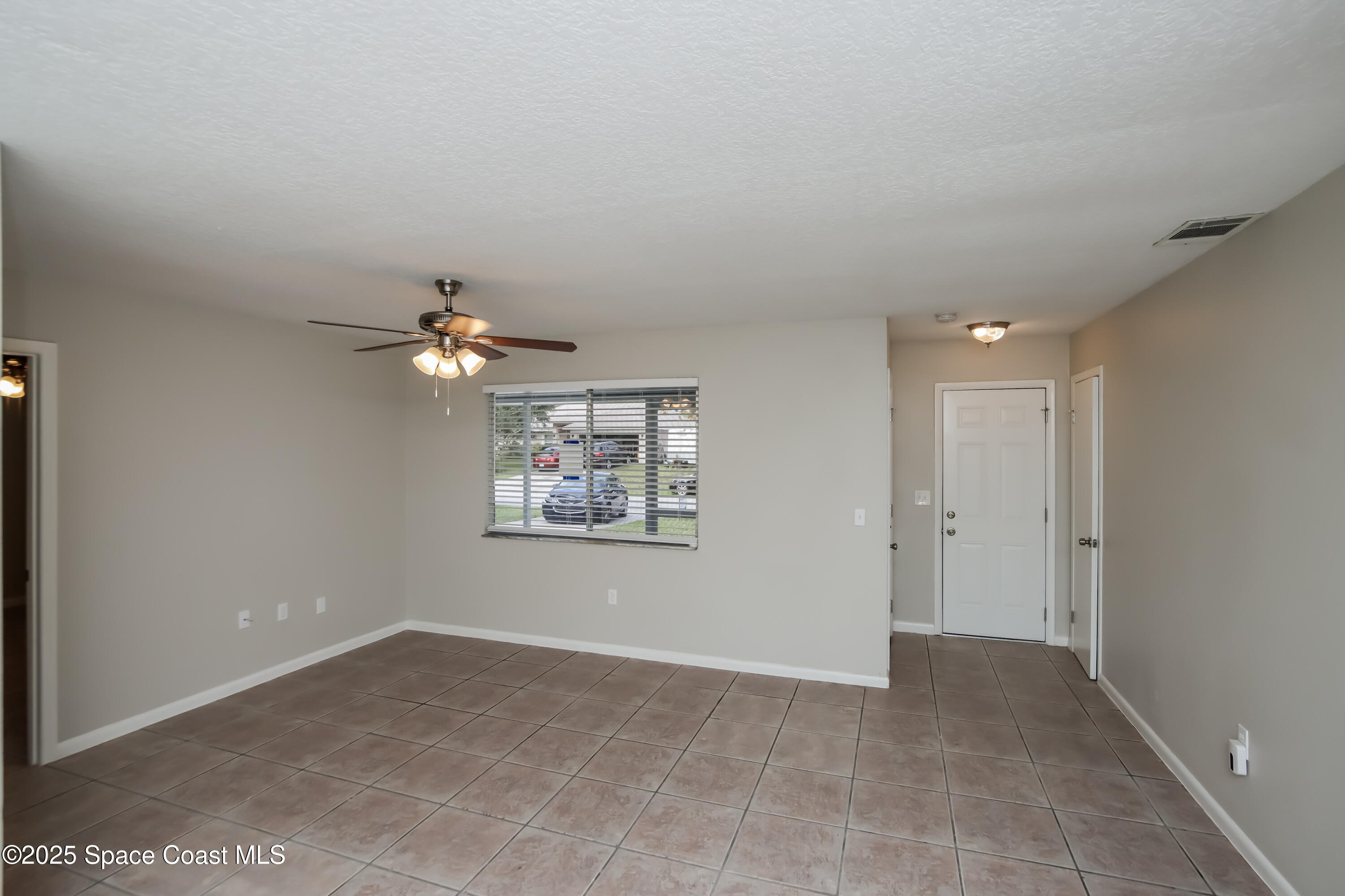 1130 Emerald Road Southeast Palm Bay, FL 32909 - Photo 4 of 16 a view of room with a ceiling fan