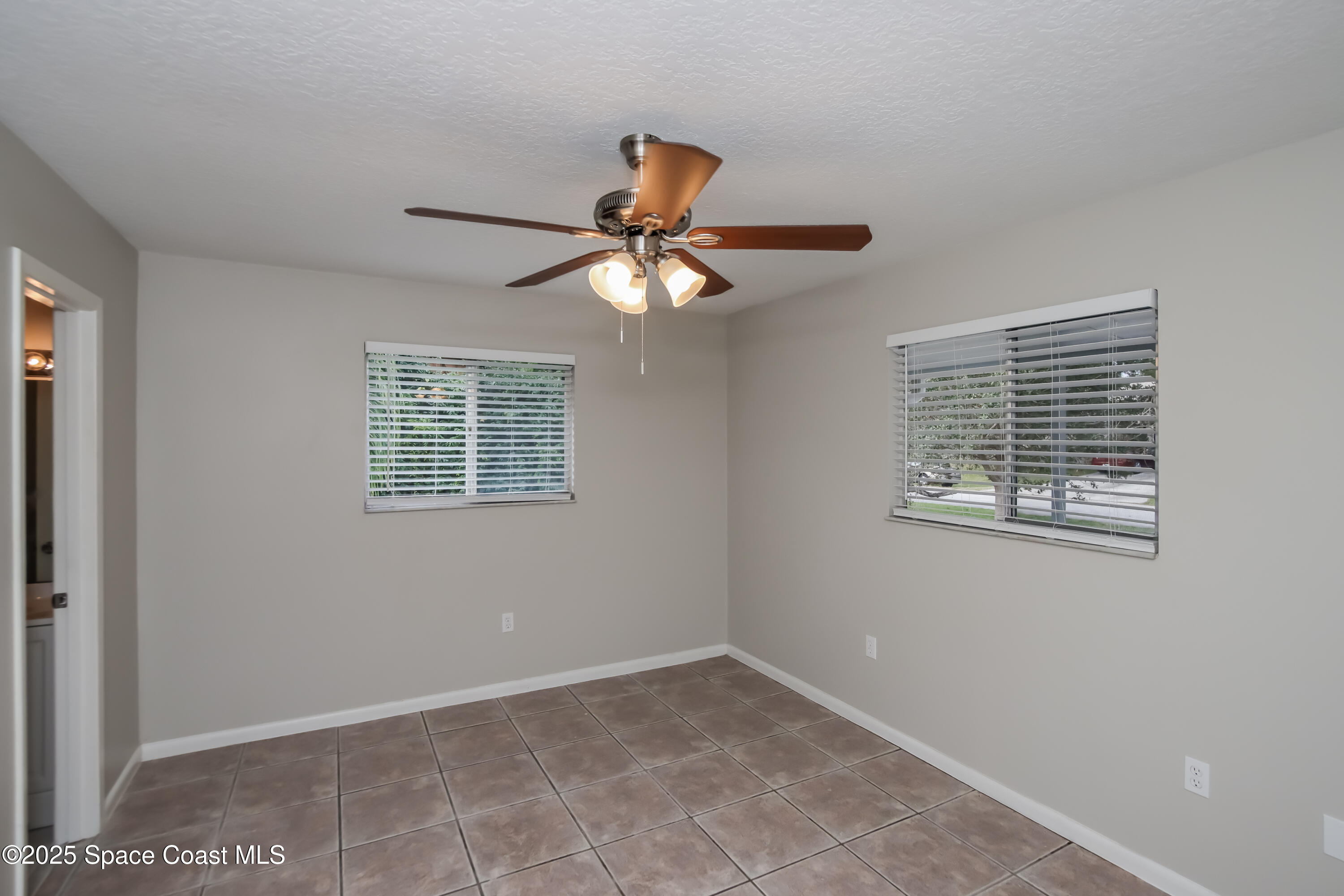 1130 Emerald Road Southeast Palm Bay, FL 32909 - Photo 7 of 16 a window in an empty room