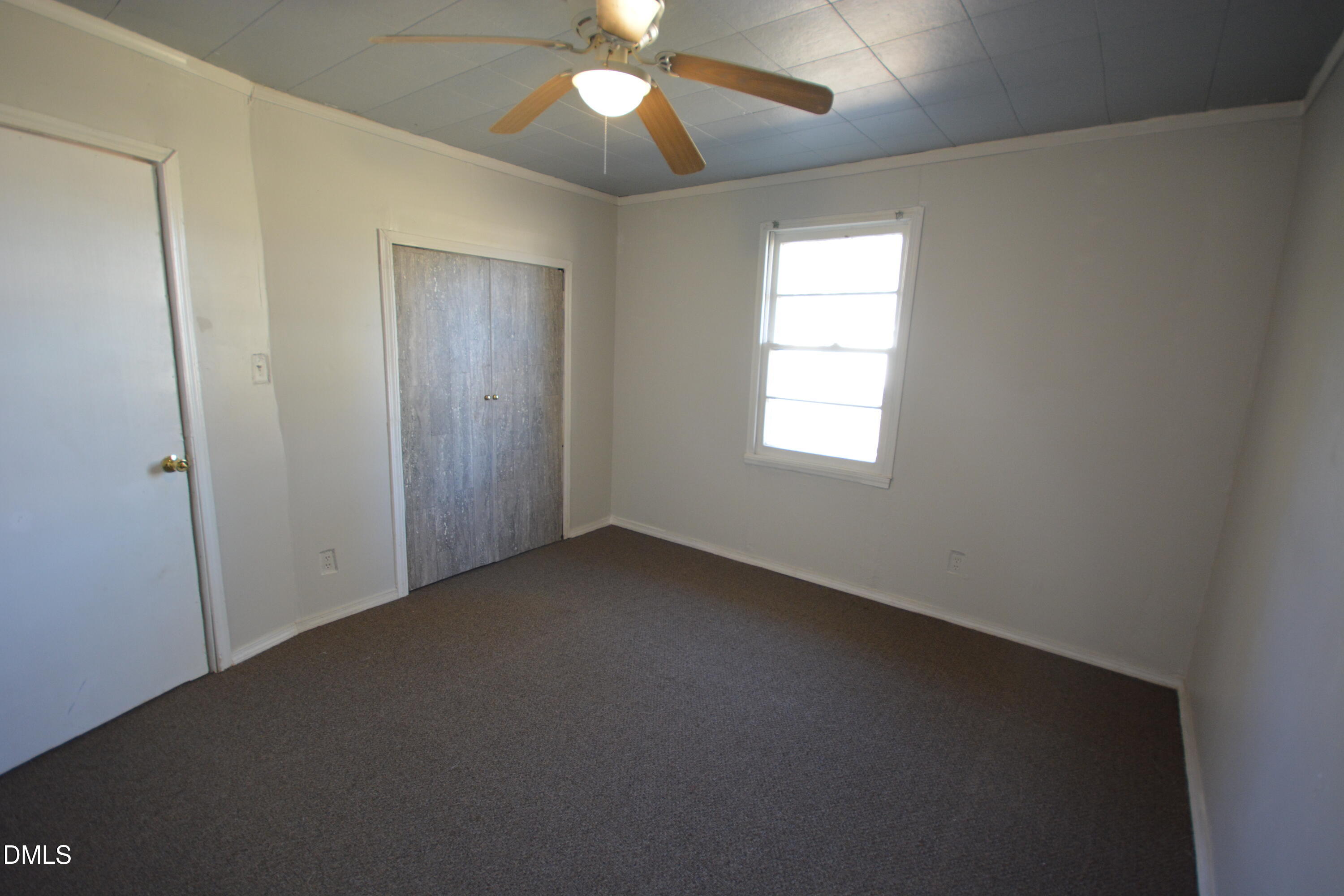 1324 Raleigh Road Oxford, NC 27565 - Photo 11 of 18 an empty room with windows and fan