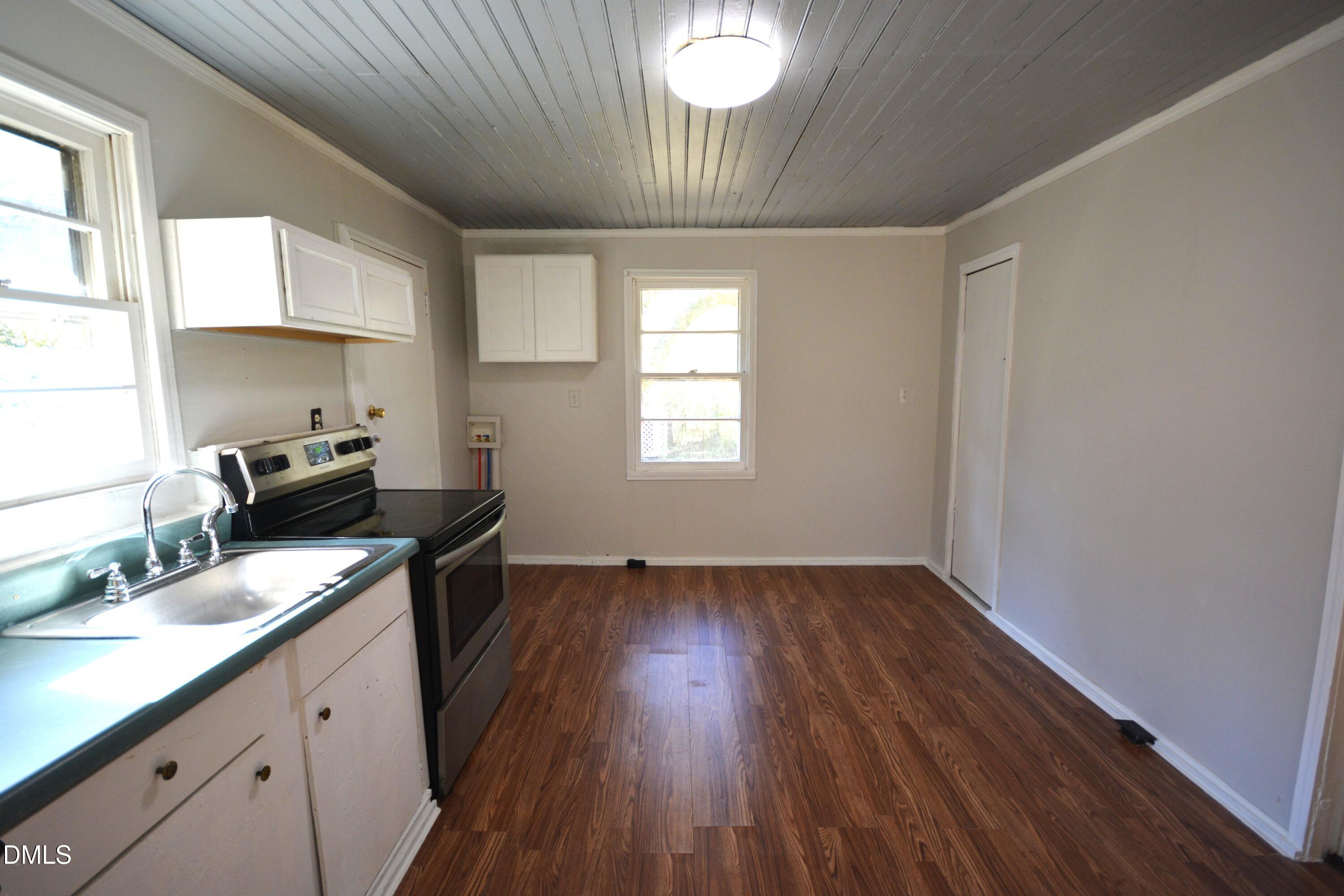 1324 Raleigh Road Oxford, NC 27565 - Photo 5 of 18 a kitchen with a sink dishwasher a refrigerator and wooden floor