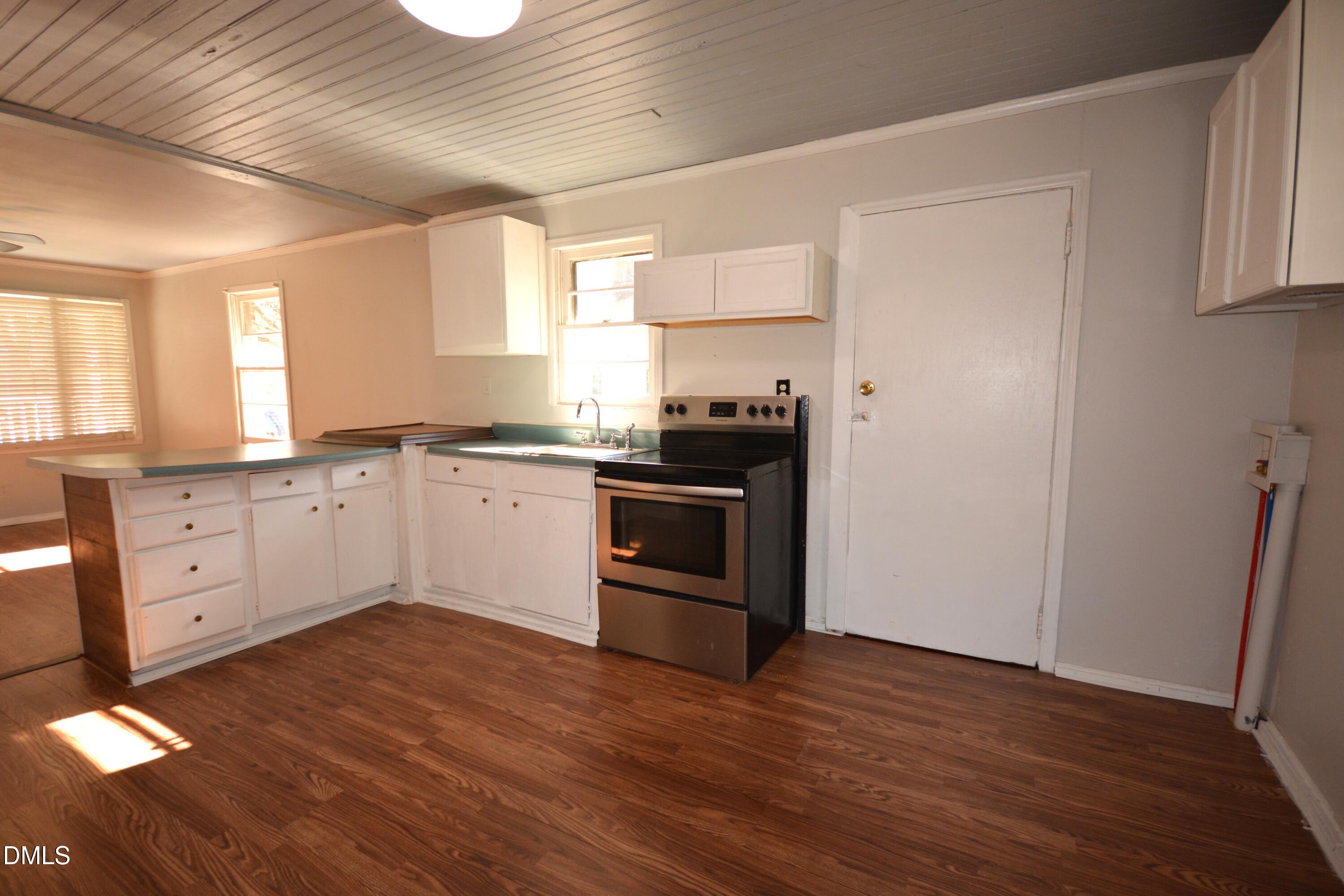 1324 Raleigh Road Oxford, NC 27565 - Photo 6 of 18 a kitchen with granite countertop a sink cabinets and wooden floor