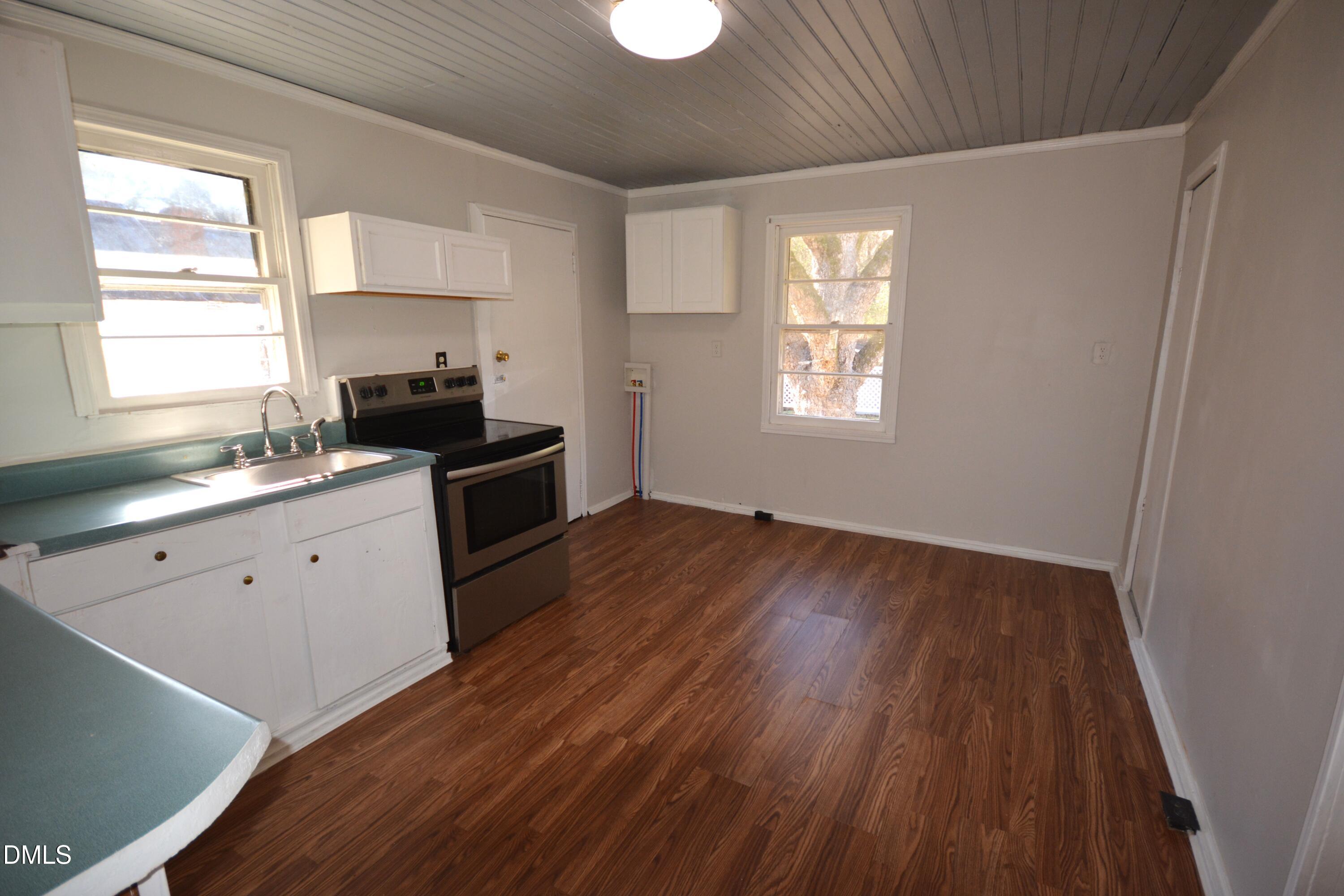 1324 Raleigh Road Oxford, NC 27565 - Photo 8 of 18 a kitchen with a sink wooden floor and a window