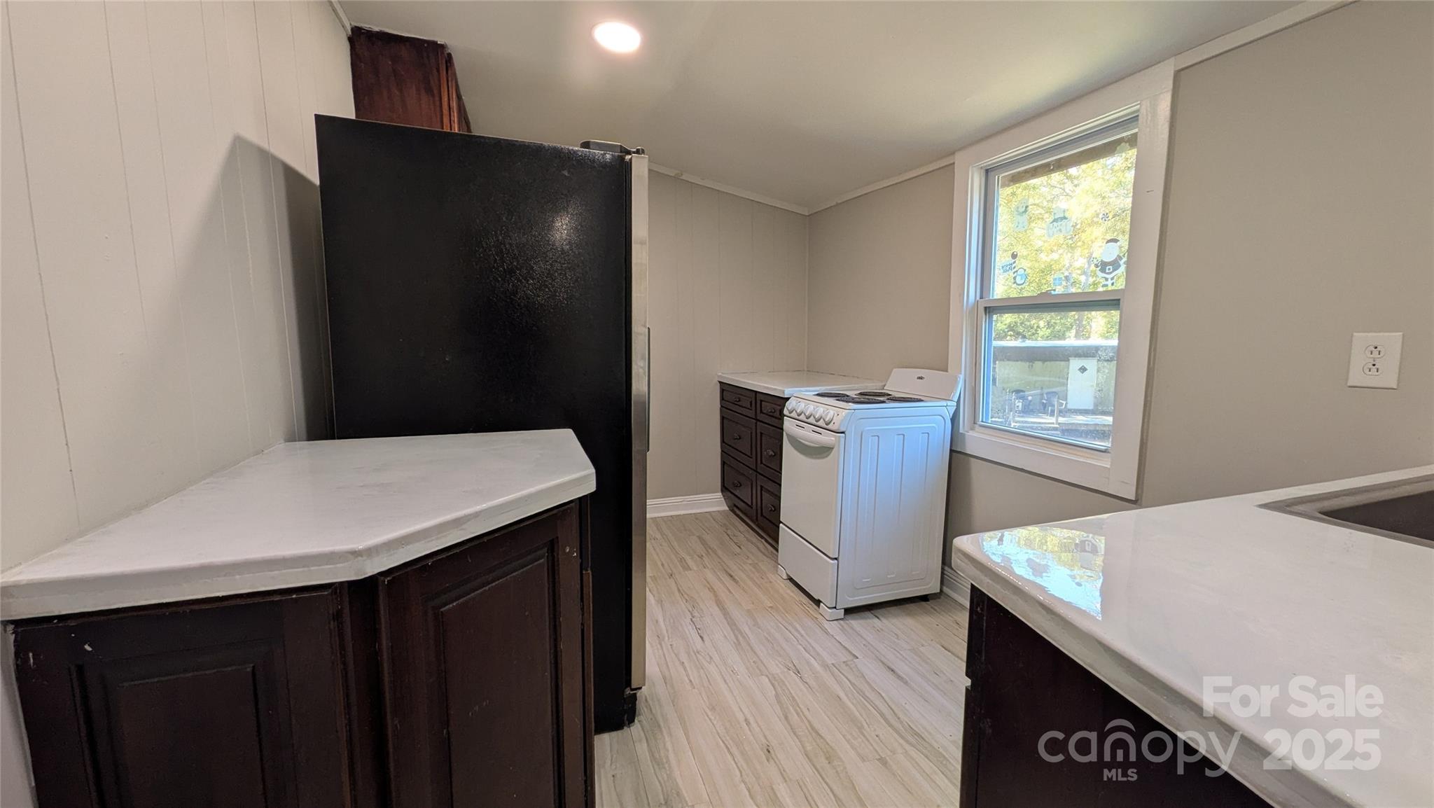 110 Dye Street Chester, SC 29706 - Photo 7 of 22 a kitchen with a wooden floor and two cabinet