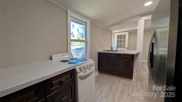 a kitchen with a sink and a stove top oven