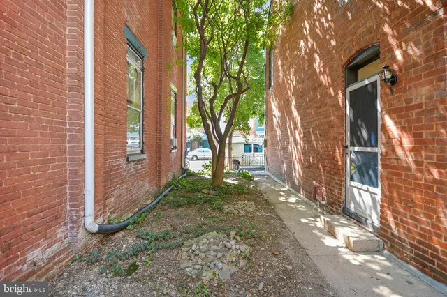 a view of a hallway with wooden floor and entryway