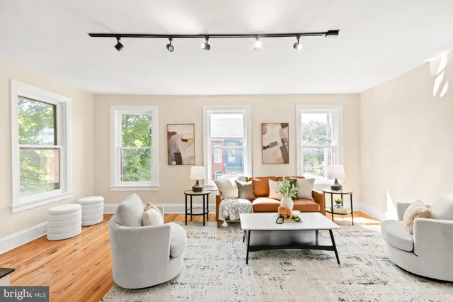 a living room with furniture a rug and a large window