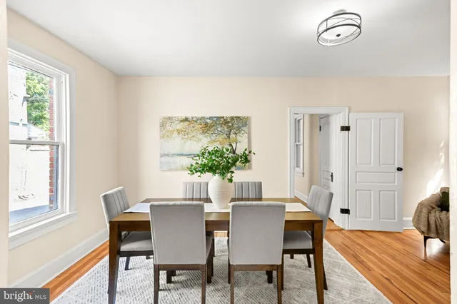 a bedroom with a bed and painting on the wall