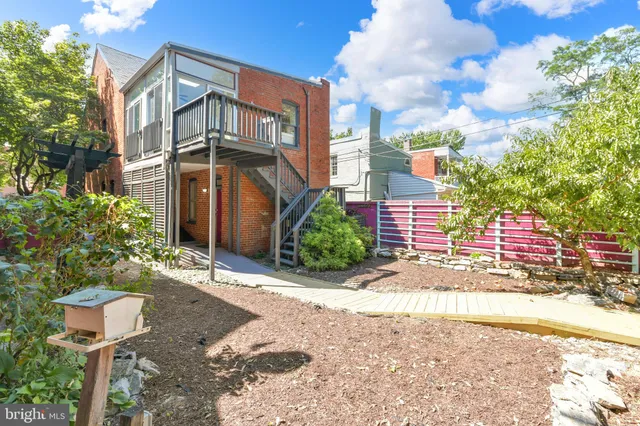a balcony with wooden floor and trees in the back