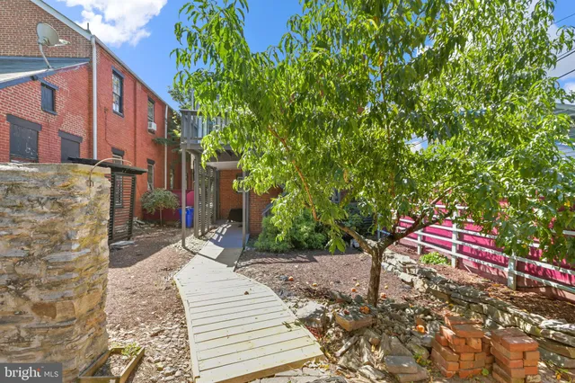 a front view of multi story residential apartment building with yard