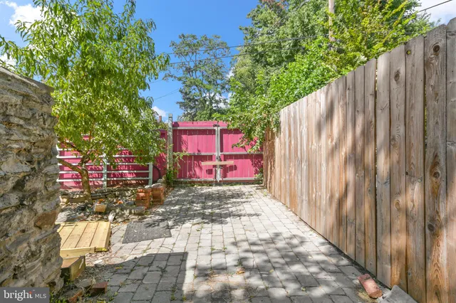 a bedroom with a bed a chandelier and a window