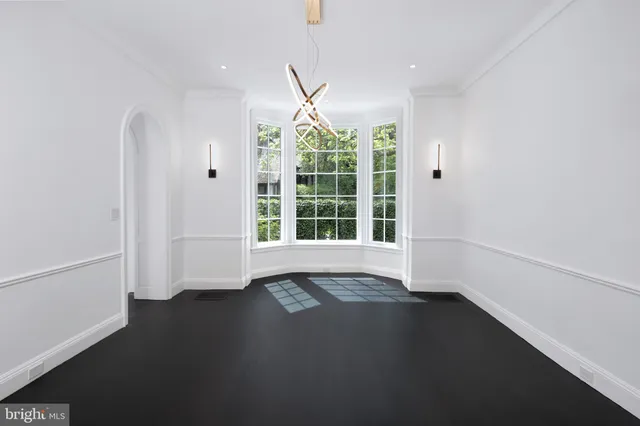 a view of a dining room with furniture a rug and wooden floor