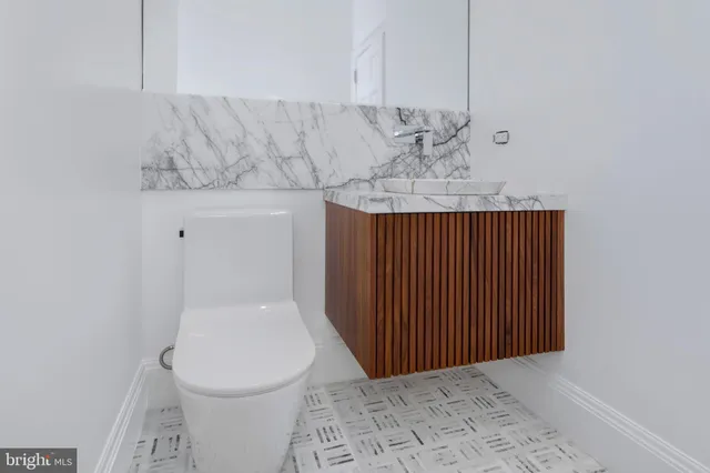a kitchen with kitchen island granite countertop wooden cabinets and a sink