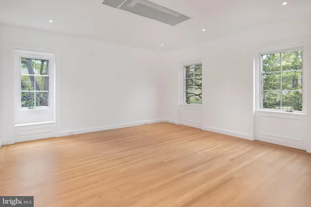 a view of room with wooden floor and white walls