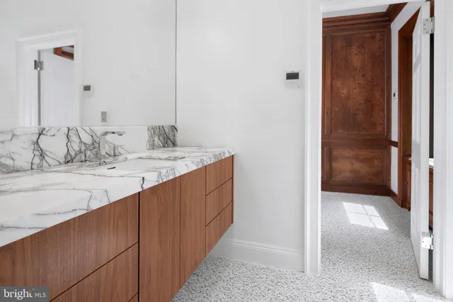 an empty room with wooden floor a fireplace and windows