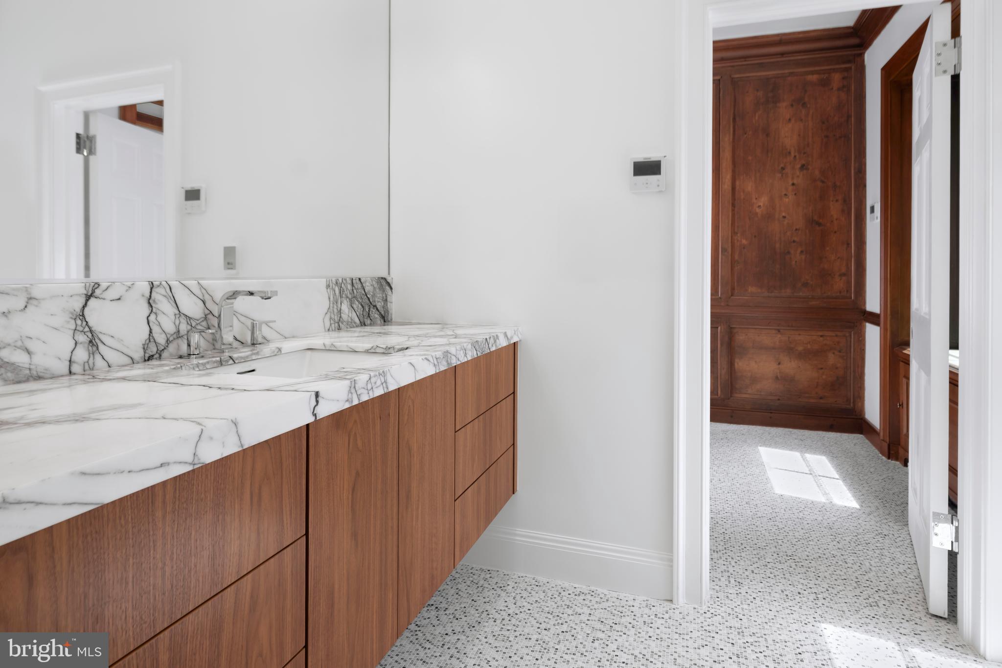 87 Library Place Princeton, NJ 08540 - Photo 36 of 60 a bathroom with a double vanity sink and a mirror