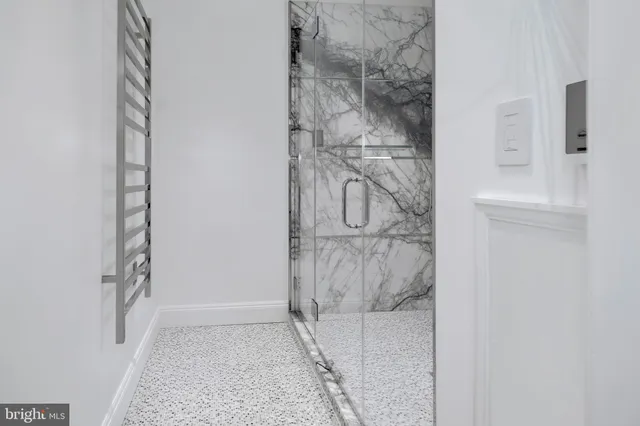a bathroom with a granite countertop shower and a sink
