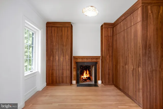 a living room with furniture a window and a fireplace
