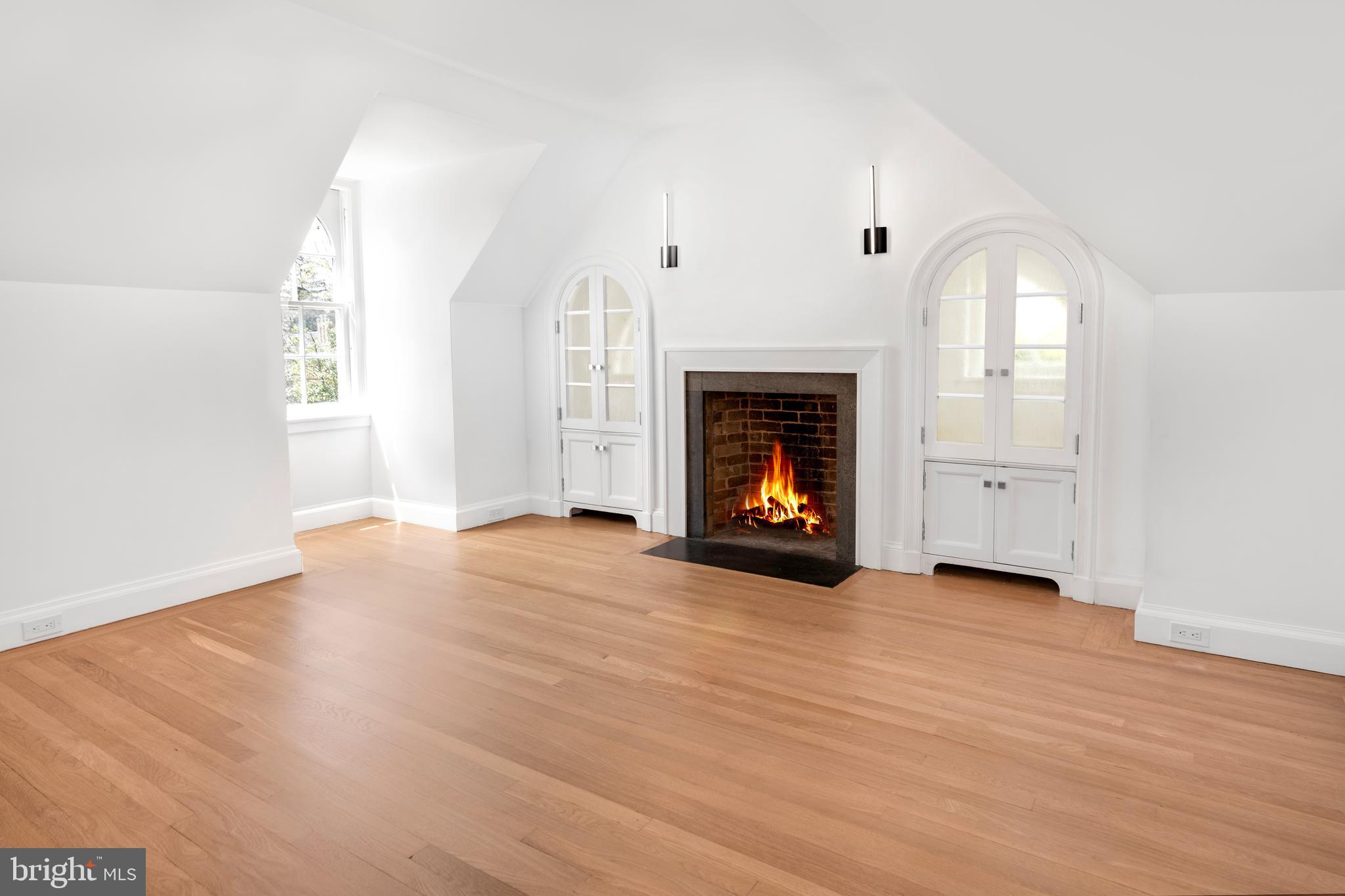 87 Library Place Princeton, NJ 08540 - Photo 49 of 60 an empty room with wooden floor a fireplace and windows