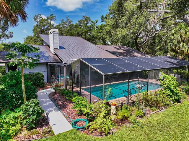a view of a house with a yard and garden