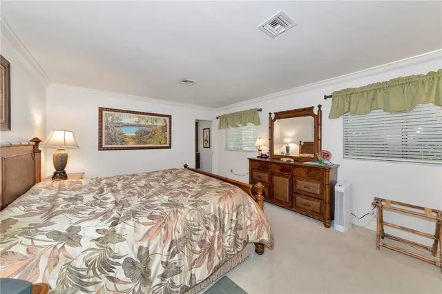 a bedroom with a bed and dresser with mirror