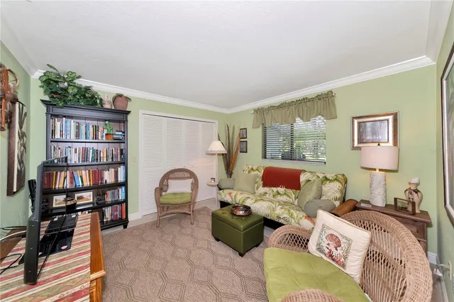 a living room with furniture and a book shelf