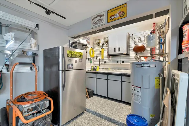 a kitchen with stainless steel appliances granite countertop a refrigerator and a stove