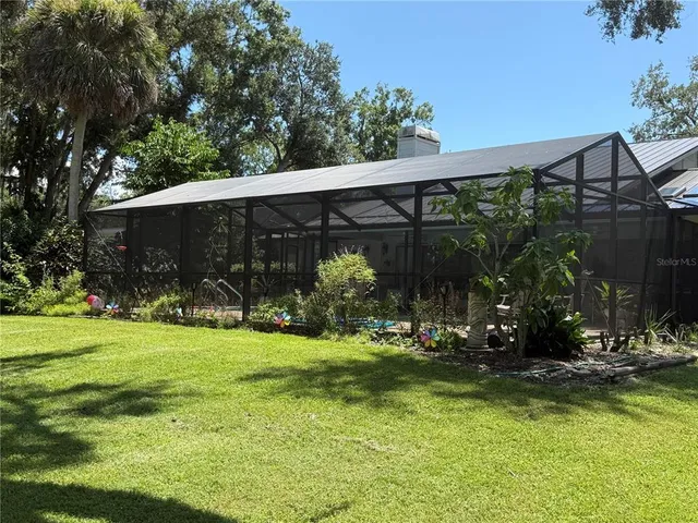 a view of a house with backyard and porch